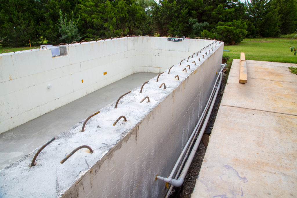 Poured ICF pool walls with stirrups at top of the wall.