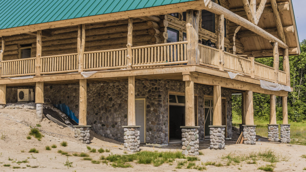 The wood columns supporting the roof and deck are in compression as they transfer the load to the solid ground beneath