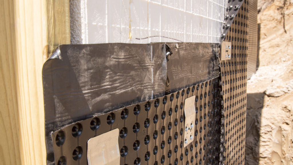 Dimple drainage mat attached to the wall
