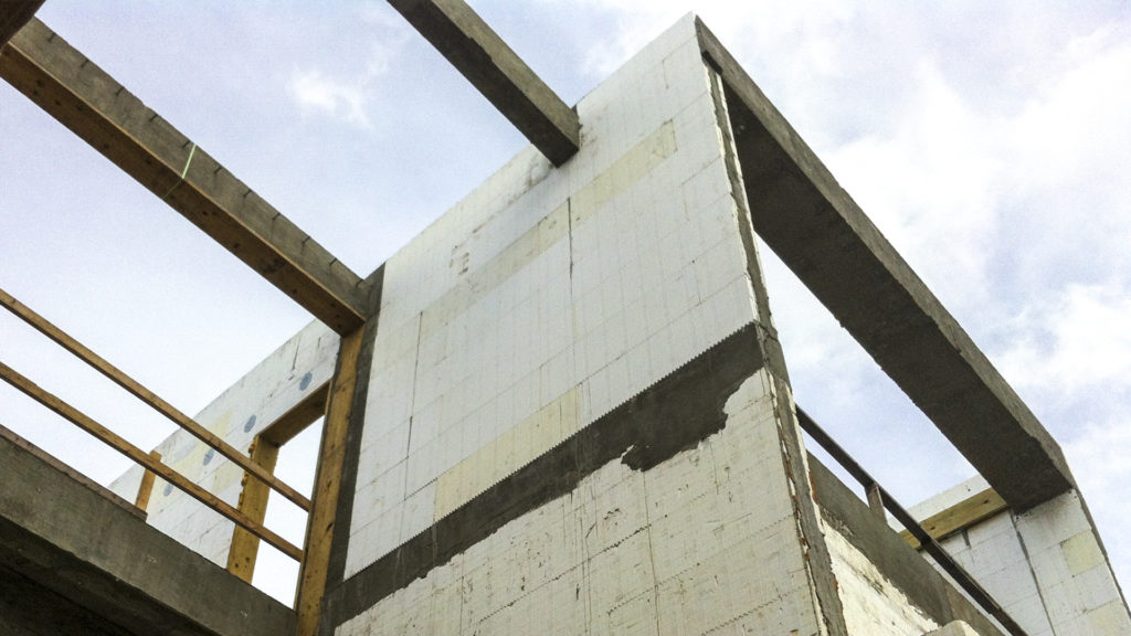 Precast concrete beam in ICF beam pocket
